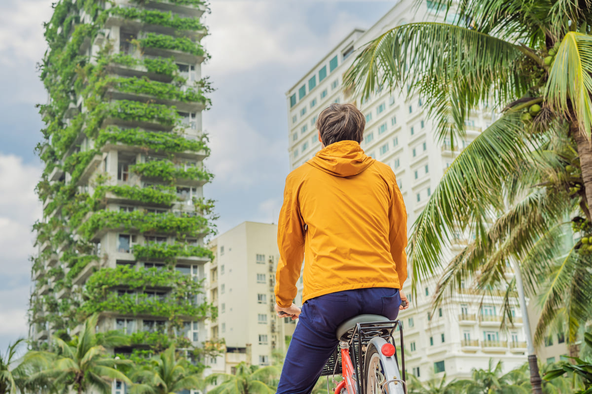 Ragazzo in bicicletta guarda palazzo green